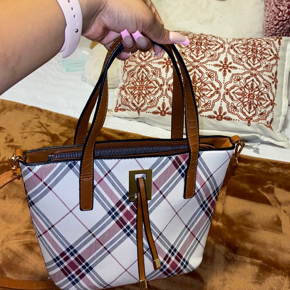 Red, black, and cream color purse.